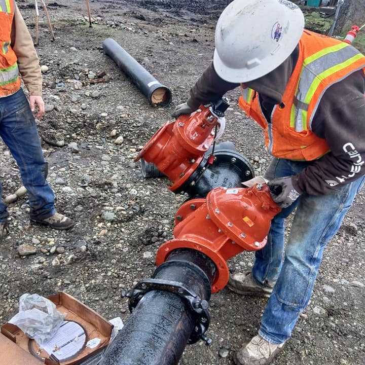 A picture of a Swick and Son's crew installing a large water main valve for a commercial property.