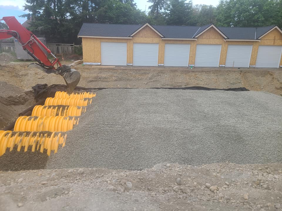 picture of a storm infiltration gallery system in front of garages at a multi-family housing new development.
